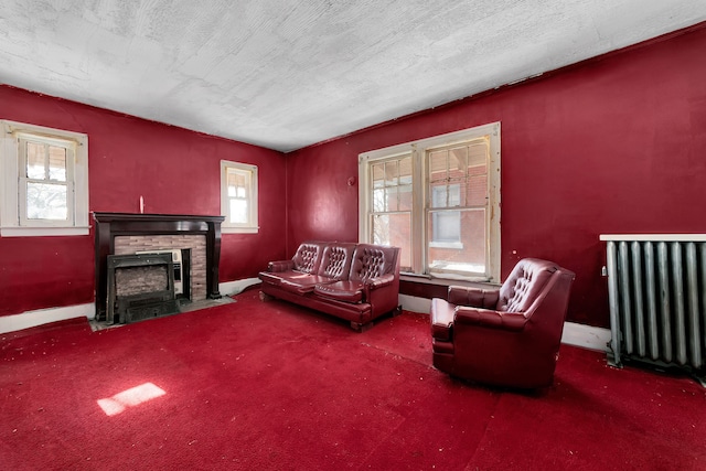 carpeted living room featuring a fireplace with flush hearth, a wealth of natural light, radiator, and a textured ceiling