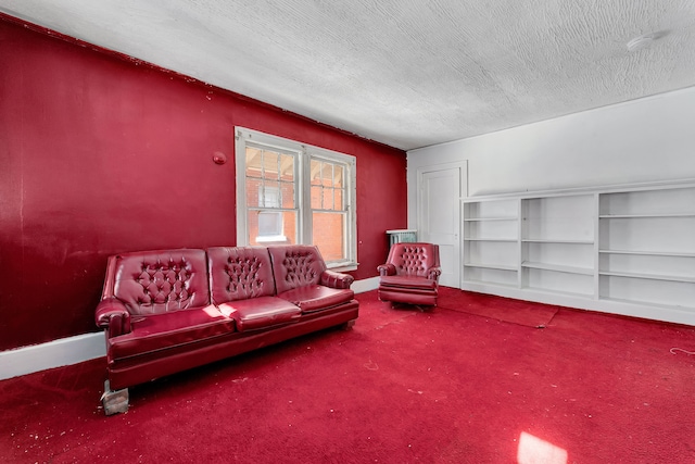 living room with a textured ceiling, carpet floors, and baseboards