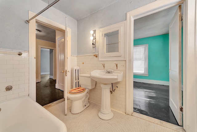 full bath featuring toilet, wainscoting, tile walls, and radiator