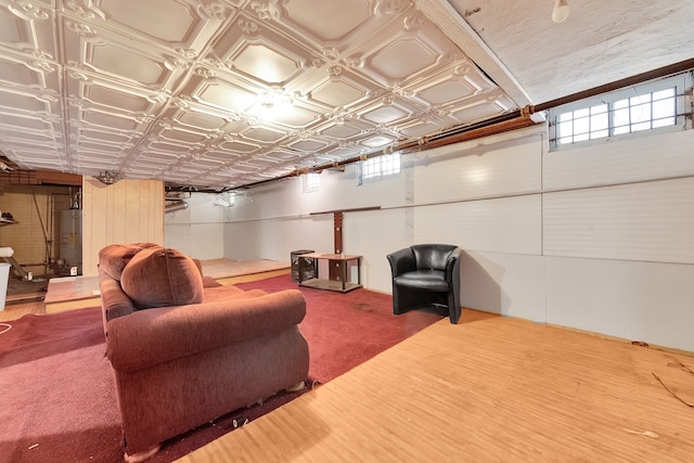 home theater featuring a wealth of natural light, an ornate ceiling, gas water heater, and wood finished floors