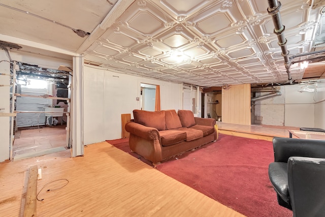 living room with an ornate ceiling and wood finished floors