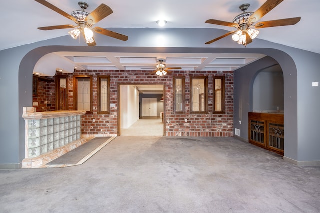 unfurnished living room with light carpet, brick wall, ceiling fan, and beam ceiling