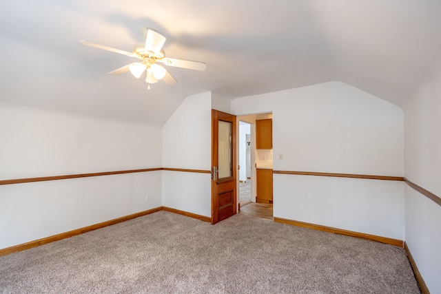 additional living space featuring lofted ceiling, carpet floors, and baseboards