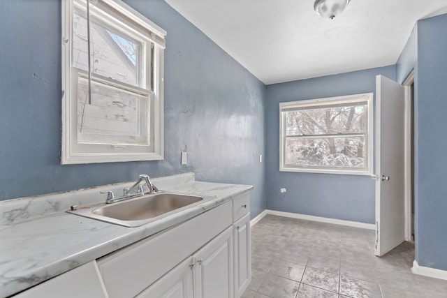 bathroom featuring tile patterned flooring, vanity, and baseboards