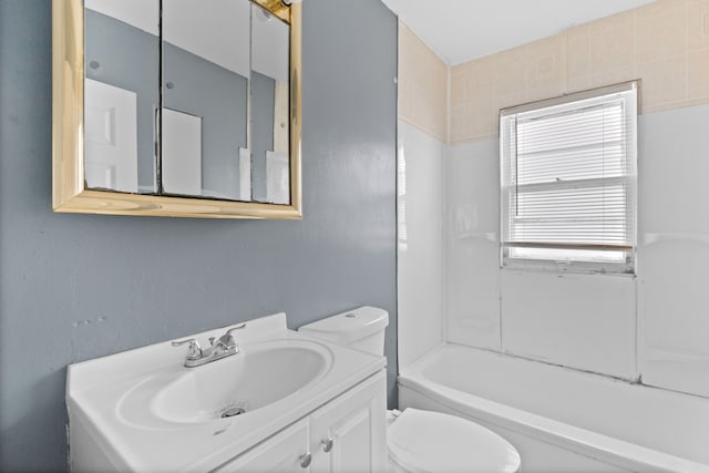 bathroom featuring toilet, shower / washtub combination, and vanity