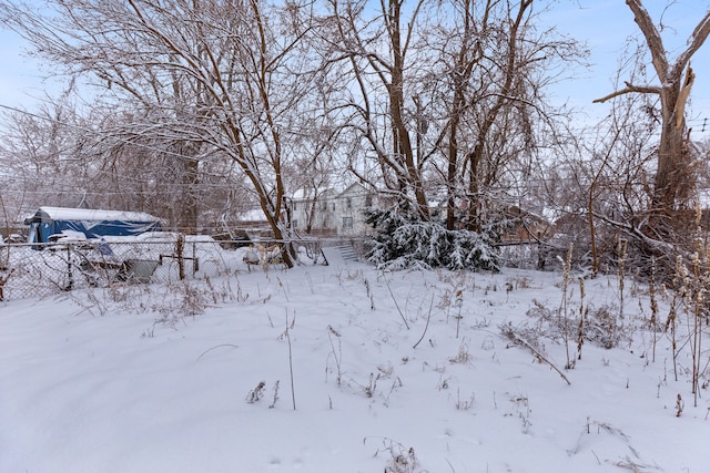 yard covered in snow with fence