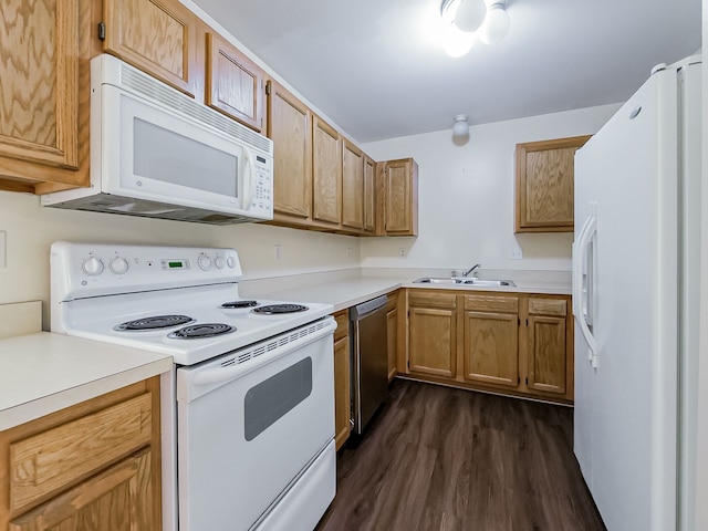 kitchen with dark wood-style flooring, light countertops, brown cabinetry, a sink, and white appliances