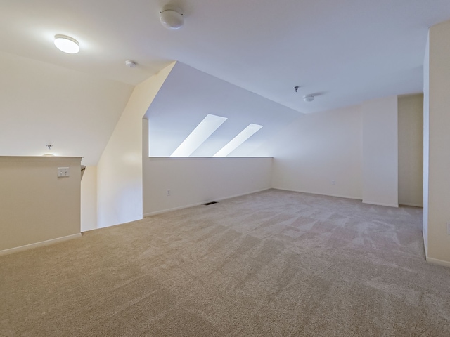 bonus room featuring vaulted ceiling, carpet floors, and visible vents