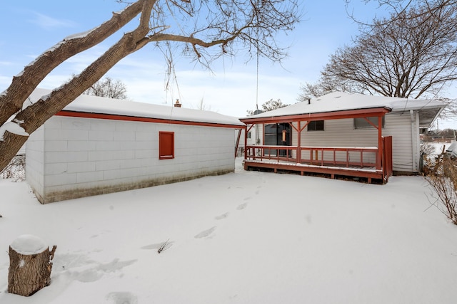 snow covered property featuring a deck