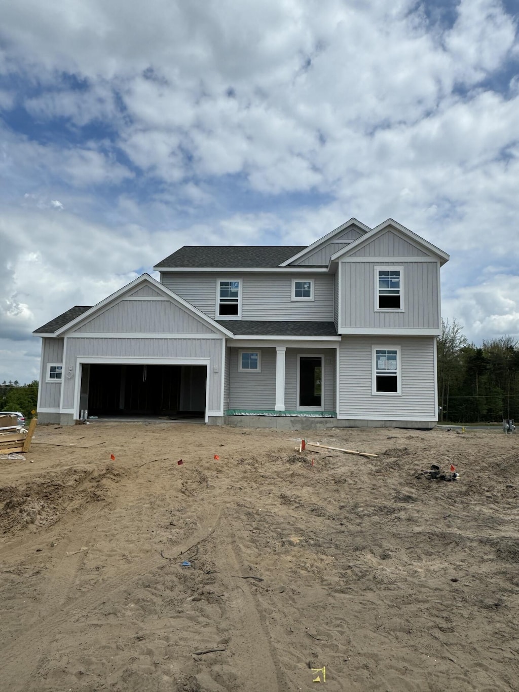 1973 Lowe Dr, Spring Lake, MI 49456 - view of front facade with a garage, board and batten siding, and driveway