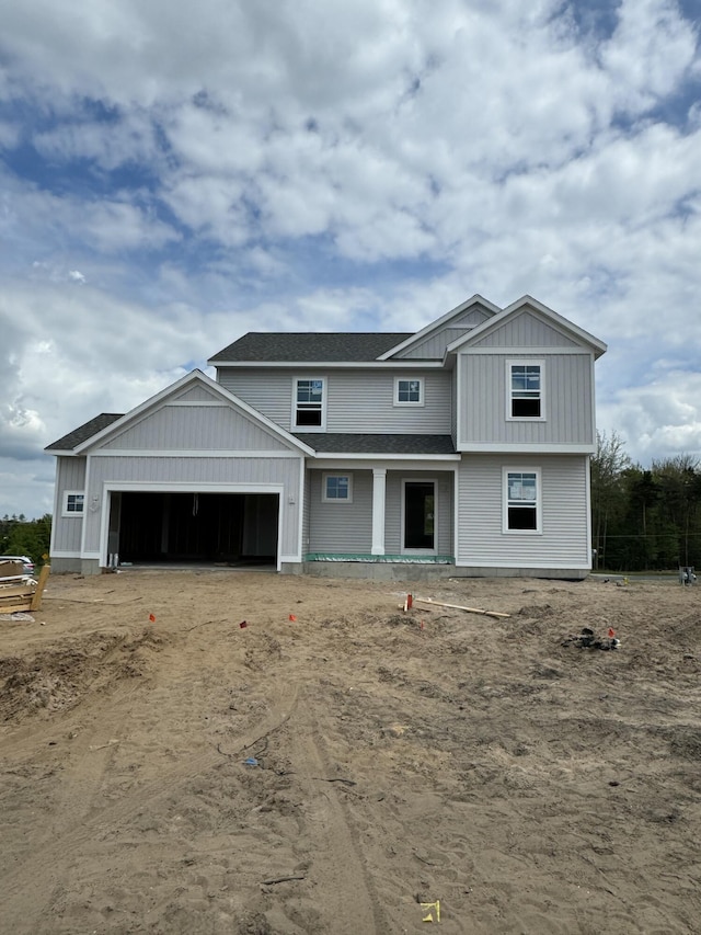 1973 Lowe Dr, Spring Lake, MI 49456 - view of front facade with a garage, board and batten siding, and driveway