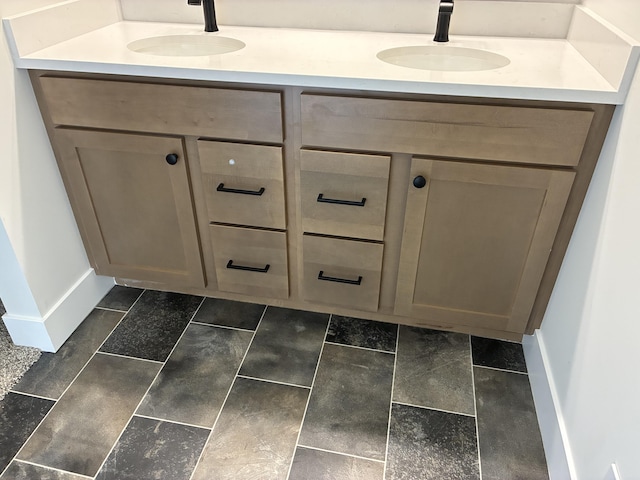 1973 Lowe Dr, Spring Lake, MI 49456 - bathroom with baseboards and double vanity