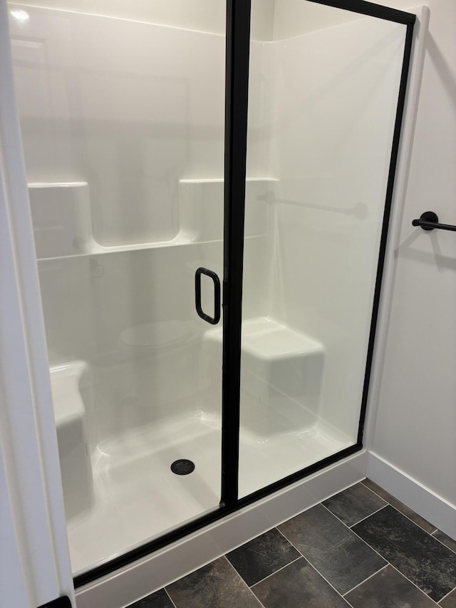1973 Lowe Dr, Spring Lake, MI 49456 - bathroom featuring a shower stall and baseboards