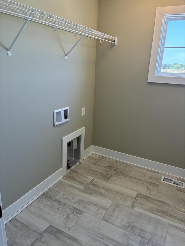 1973 Lowe Dr, Spring Lake, MI 49456 - washroom with baseboards and washer hookup