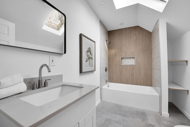 bathroom with lofted ceiling with skylight, shower / bath combination, vanity, and baseboards