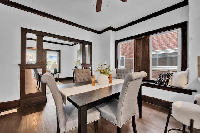 dining area with ceiling fan, baseboards, wood finished floors, and ornamental molding