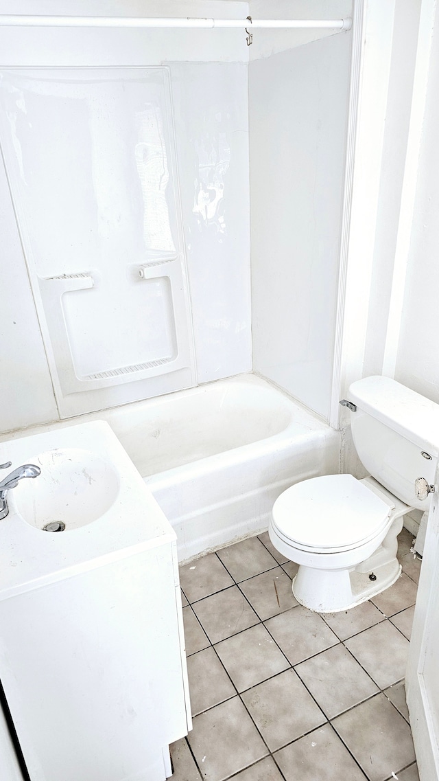 bathroom featuring vanity, bathing tub / shower combination, tile patterned flooring, and toilet