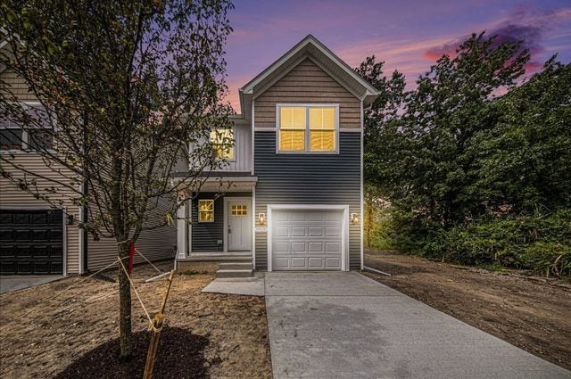 traditional-style home featuring driveway and an attached garage