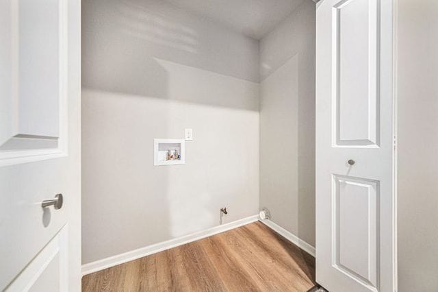 laundry room with laundry area, baseboards, gas dryer hookup, hookup for a washing machine, and light wood-style floors