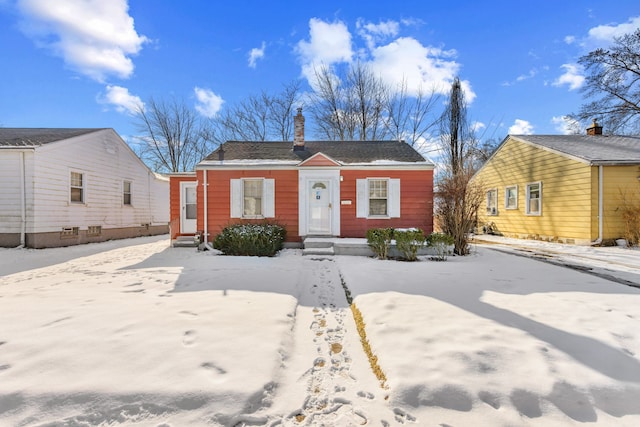 bungalow featuring entry steps and a chimney