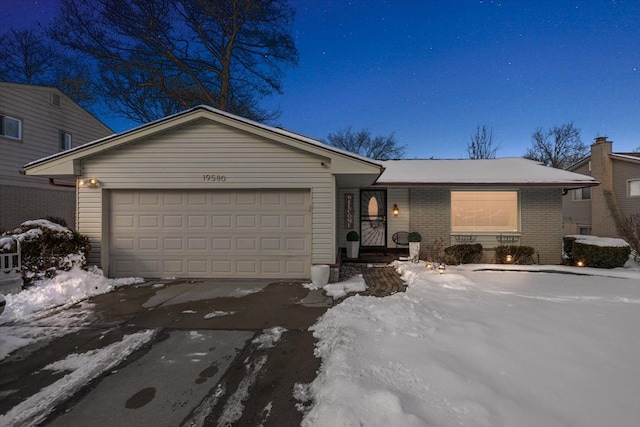 ranch-style house with an attached garage and brick siding