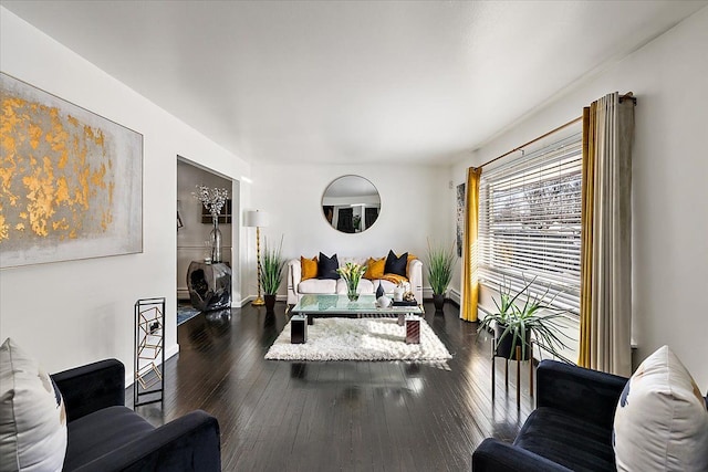 exercise room featuring baseboards and dark wood finished floors