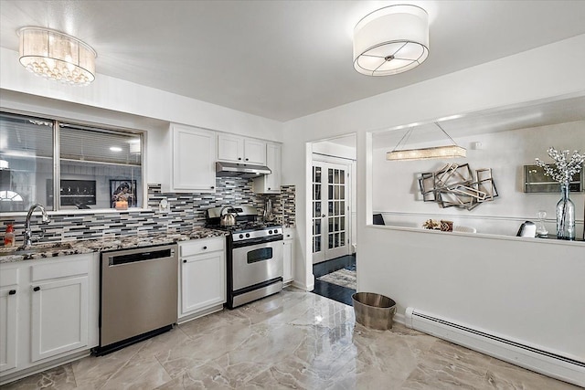 kitchen featuring under cabinet range hood, a sink, white cabinets, appliances with stainless steel finishes, and baseboard heating