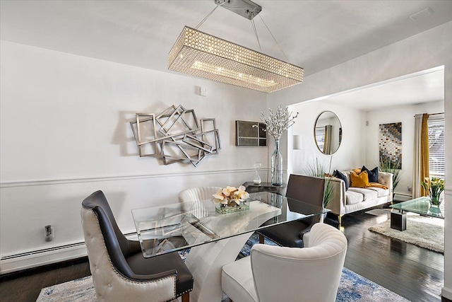 dining space with dark wood-type flooring, a baseboard radiator, vaulted ceiling, and a notable chandelier