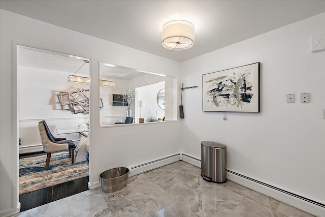 dining area with marble finish floor, baseboards, and baseboard heating