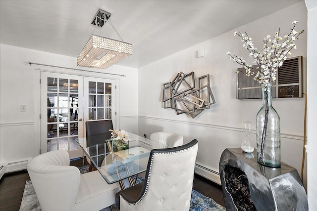 dining room with dark wood-style floors, baseboard heating, and french doors