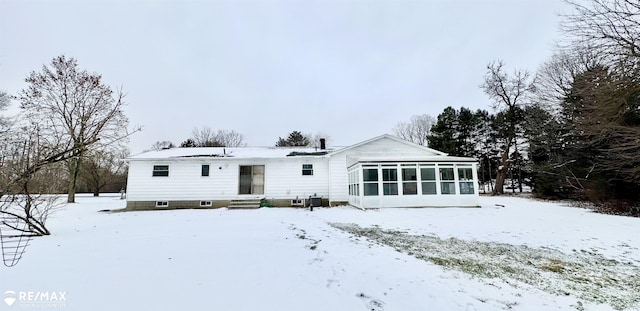 view of front of home featuring entry steps, cooling unit, and a sunroom