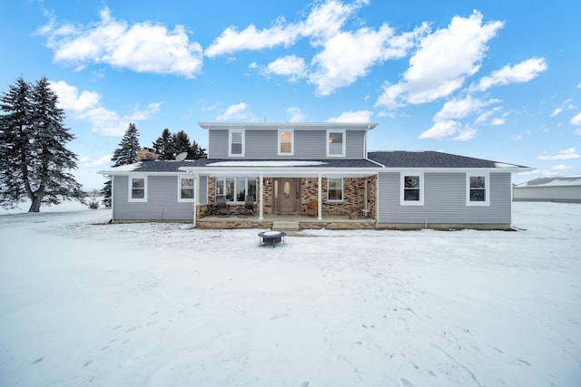 snow covered property featuring a porch