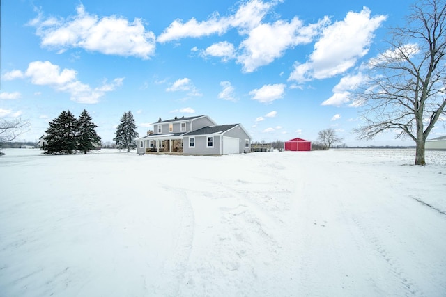 yard covered in snow featuring a garage