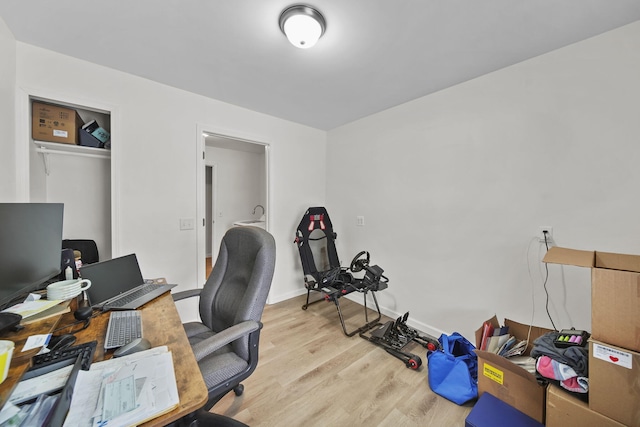 home office with light wood finished floors and baseboards