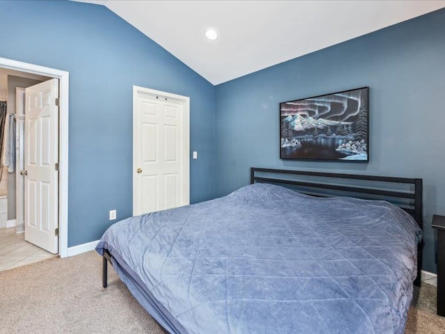 carpeted bedroom with baseboards and vaulted ceiling