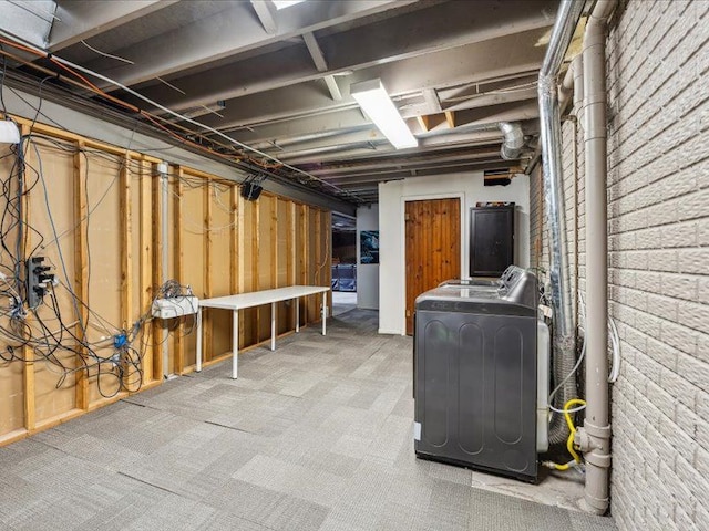 unfinished basement featuring carpet and washer and clothes dryer