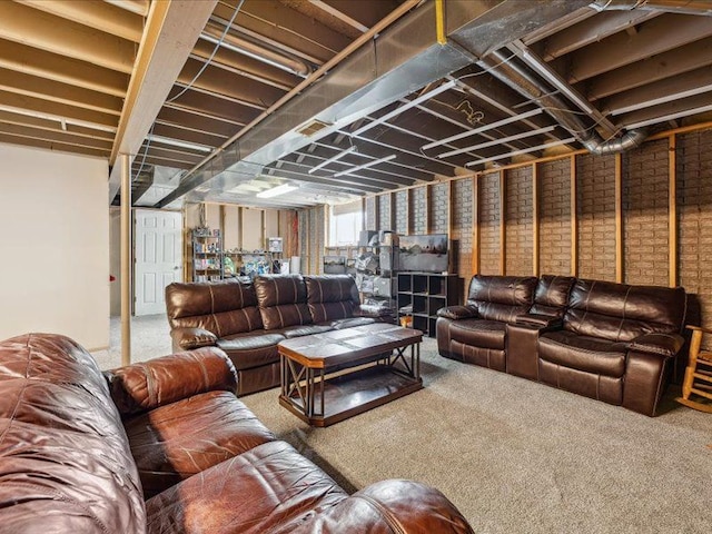 carpeted living room featuring brick wall