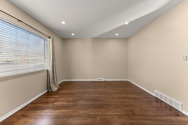 unfurnished room featuring recessed lighting, visible vents, and dark wood finished floors