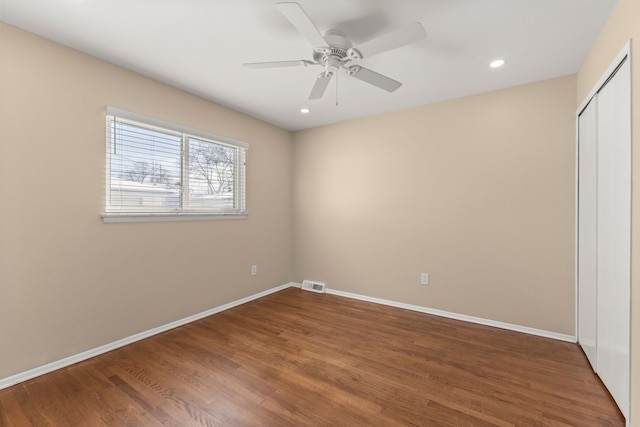 unfurnished bedroom with recessed lighting, wood finished floors, visible vents, baseboards, and a closet