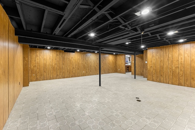 finished basement featuring wooden walls