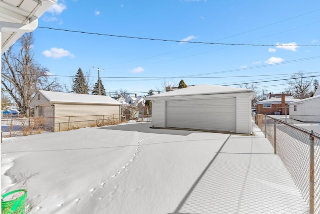 view of yard with a detached garage, fence, and an outdoor structure