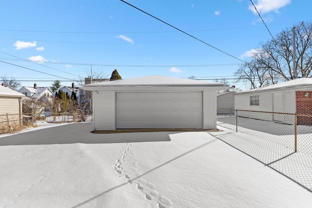 detached garage featuring fence