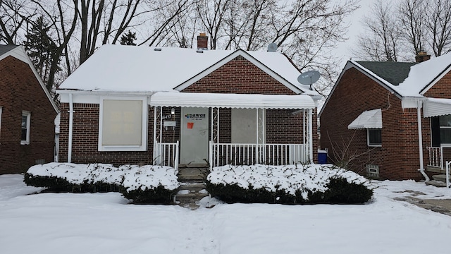 bungalow-style home featuring brick siding