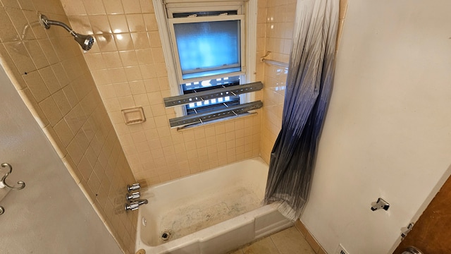 full bathroom featuring baseboards, shower / tub combo, and tile patterned floors