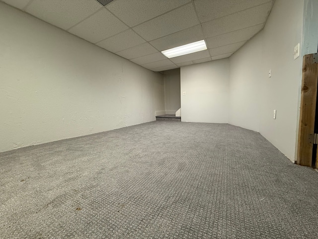 carpeted spare room with a paneled ceiling