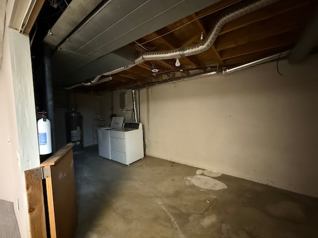 unfinished basement with water heater and washer and clothes dryer