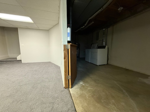 finished basement featuring a drop ceiling and washer and dryer