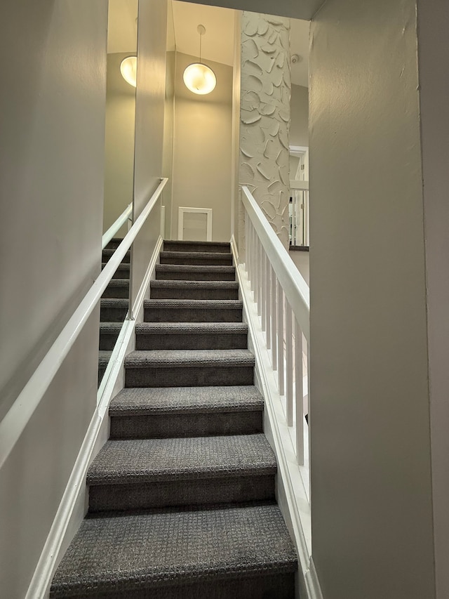 stairway featuring baseboards