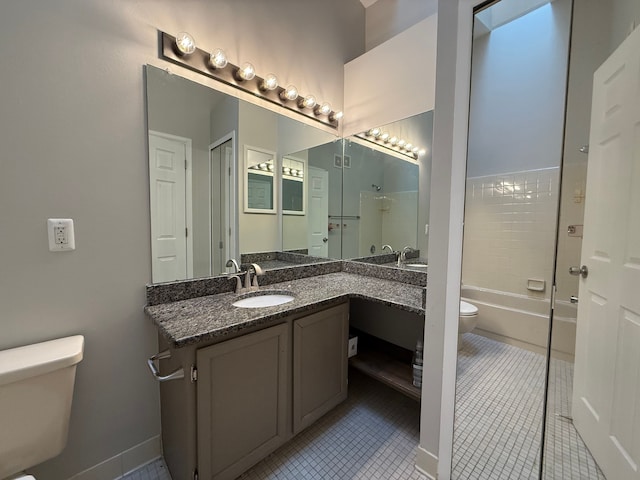 bathroom featuring washtub / shower combination, vanity, tile patterned flooring, and toilet