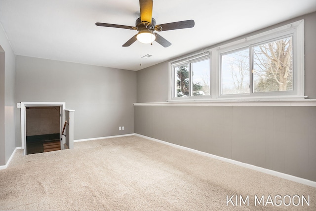 unfurnished living room with a ceiling fan, carpet, visible vents, and baseboards